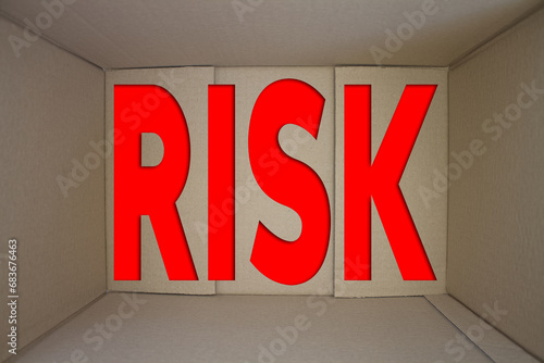 Risk word with cardboard box. Brown folded card box.