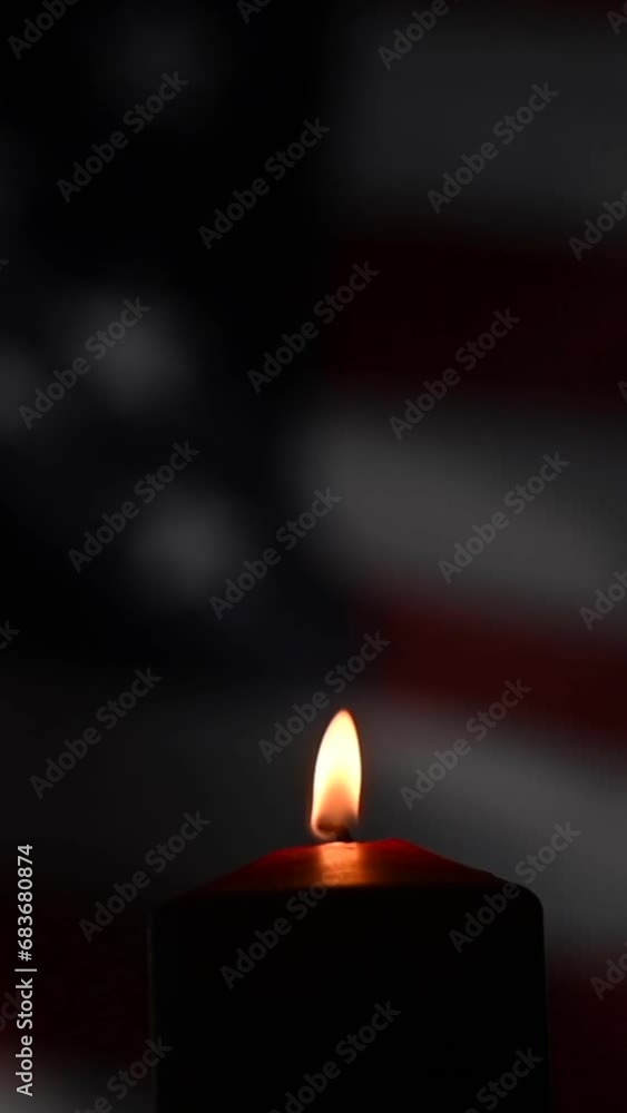 A candle burns against the background of the US flag. Independence Day. Vertical video. A candle burns against the background of the US flag. Independence Day. Vertical video.