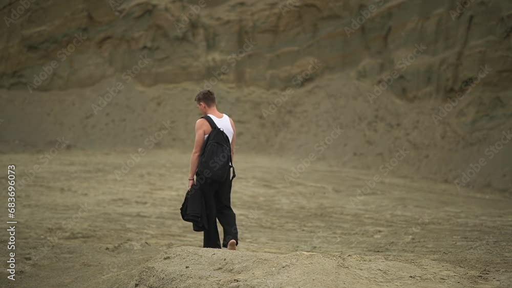 man in the desert. a man walks into the distance. slow-motion video. High-quality shooting in 4K format man in the desert. a man walks into the distance. slow-motion video. High-quality shooting in 4K format