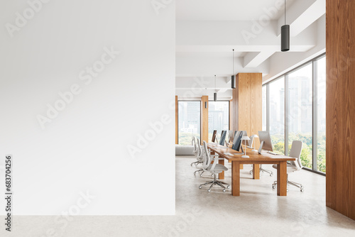Light coworking interior with pc desktop and table near window. Mock up wall