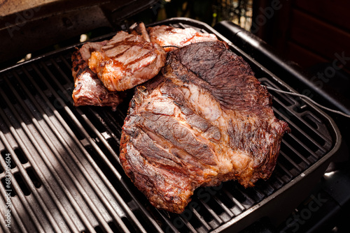 Riesiges Tomahawk Steak am Grill - huge Tomahawk Steak on the grill photo