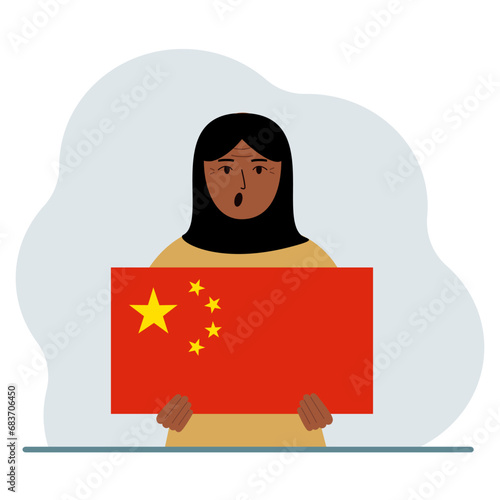 A woman holds a Chinese flag. The concept of demonstration, national holiday or patriotism. Nationality.