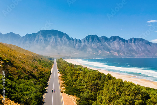 Kogelbay Beach Western Cape South Africa, Kogelbay Rugged Coast Line with spectacular mountain road. Garden Route. couple of men and women walking on the road, drone aerial view photo