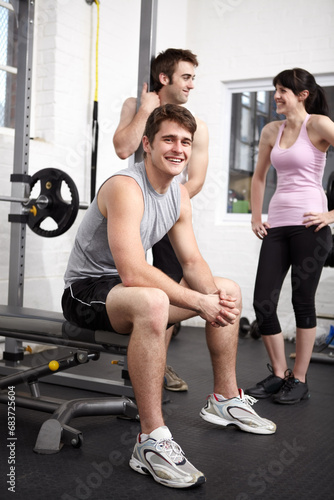 Gym, group and man with portrait, smile and fitness with happiness, workout routine and training. People, athlete and motivation with conversation, exercise and joy with progress, chatting and relax