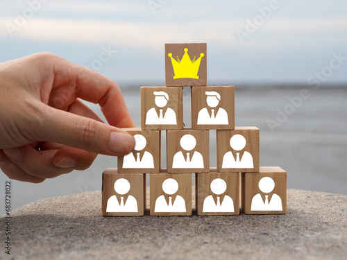Man icon with crown on wooden block, business success leader