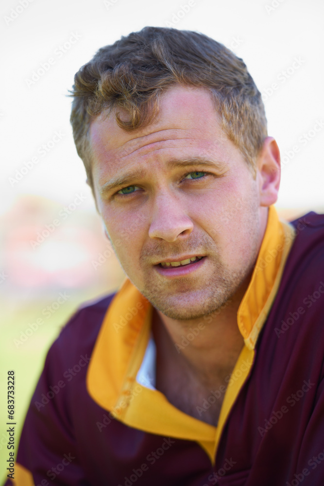 Portrait, closeup and male rugby player ready for sports practice outside looking serious. Focus, face and man outdoors on field for athletic and competitive game exercise with fitness training Portrait, closeup and male rugby player ready for sports practice outside looking serious. Focus, face and man outdoors on field for athletic and competitive game exercise with fitness training