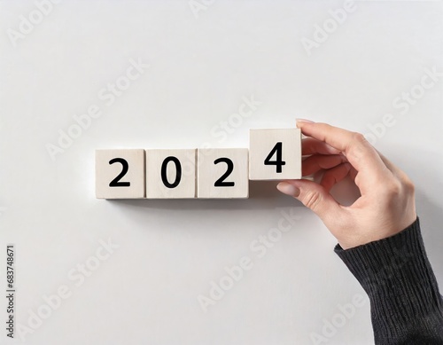 2024 Happy New Year eve wooden blocks flip change hand, countdown starting ending 2023, action schedule calendar strategy future vision, business startup plan resolution, celebration