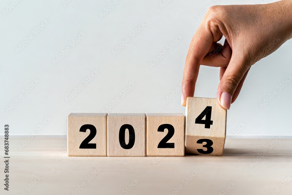 Naklejka premium 2024 Happy New Year eve wooden blocks flip change hand, countdown starting ending 2023, action schedule calendar strategy future vision, business startup plan resolution, celebration