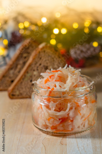 salted cabbage in a jar and grain bread on a New Year s background