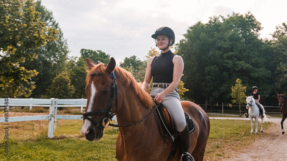 Young woman and her beautiful red horse during calm trail ride. Ecotourism and animal care concepts. Young woman and her beautiful red horse during calm trail ride. Ecotourism and animal care concepts.