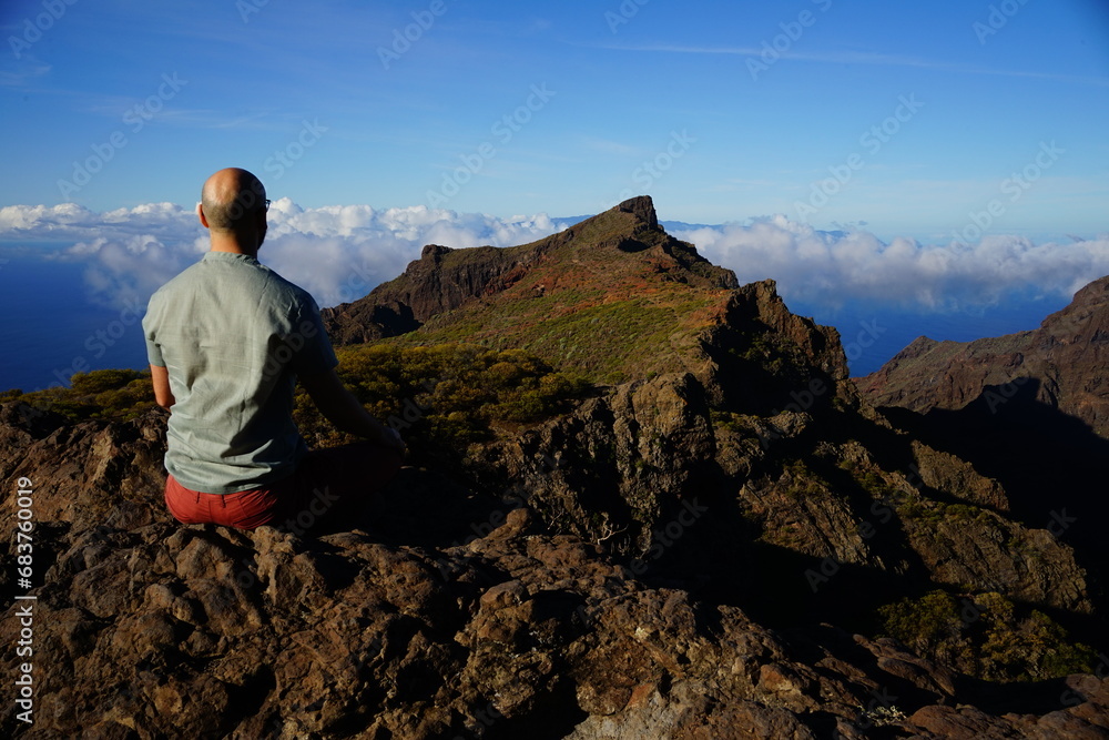 Meditative man on the top of Teno mountains, Tenerife, Canaries, Spain