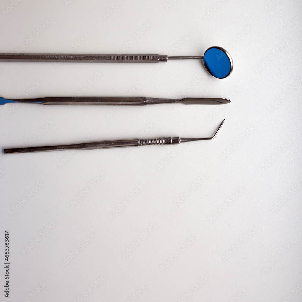 Dental tools on silver color background Dental tools on silver color background