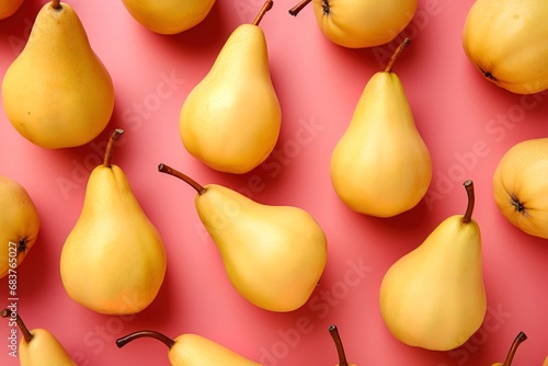 ripe fresh yellow pears on a pink background top view