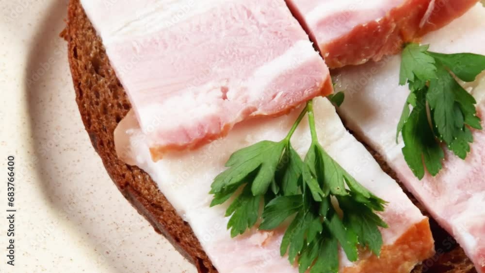 Open sandwich with boiled-smoked pork belly slices on saucer Open sandwich with boiled-smoked pork belly slices on saucer