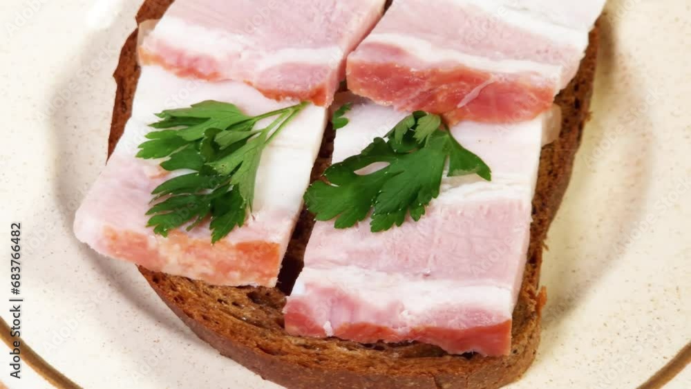 Open sandwich with boiled-smoked pork belly slices on saucer Open sandwich with boiled-smoked pork belly slices on saucer