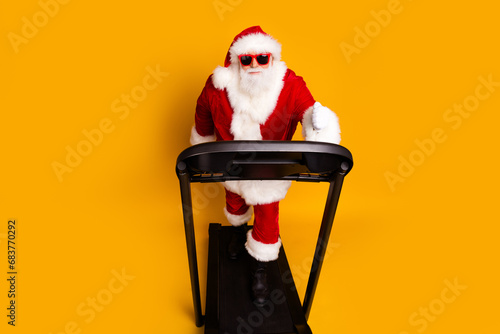 Full length photo of energetic joyful pensioner santa claus running slimming isolated on yellow color background photo
