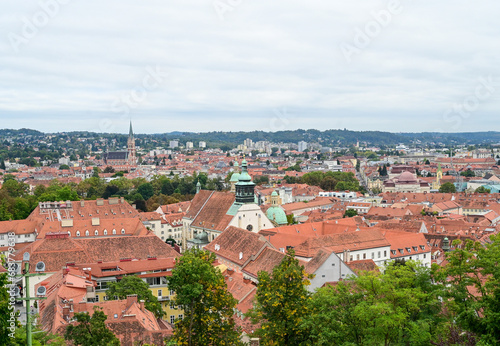 Graz, Austria: Panoramic view of the city. Buildings, houses, streets and red roofs of Graz. Old town, view from the castle. 