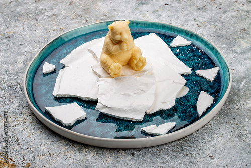 Ice cream shaped like a teddy bear sitting on ice floes s ice cream. Haute cuisine. photo