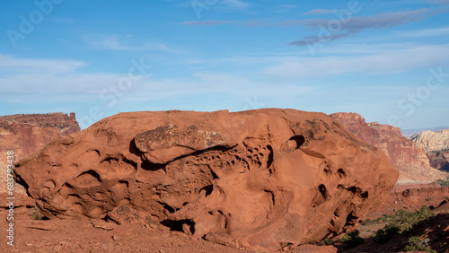 Sandstone rock formation in the American Southwest. Establishing image of the high desert showing massive rock formations with sparse juniper and sagebrush vegetation