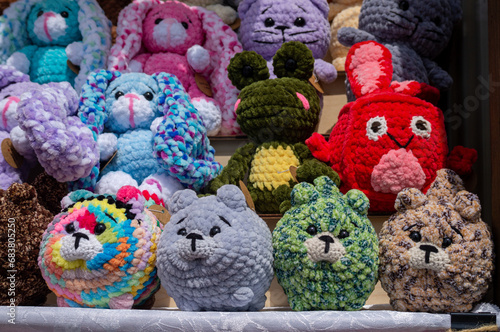 Soft handmade knitted toys stand on shelves for sale © Alexander