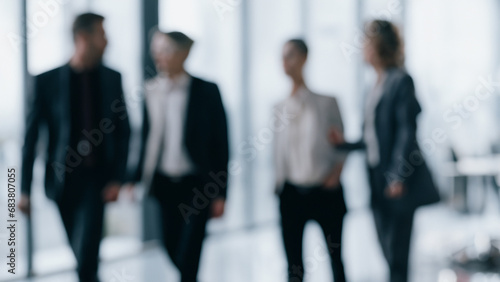 unrecognizable motion blurred business people in an office. Abstract office background