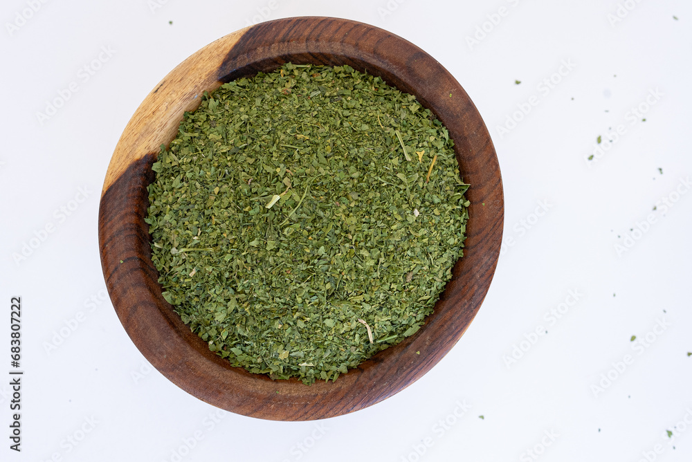 dried parsley in brown wooden plate on blue marble
dried parsley in brown wooden plate on blue marble
