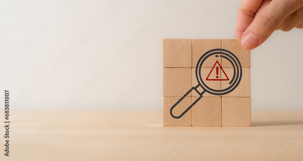 Risk analysis and management concept. Identify potential risks and develop strategies to mitigate. Wooden cube blocks with magnifying glass and triangle caution warning sign. VUCA management concept. - obrazy, fototapety, plakaty 