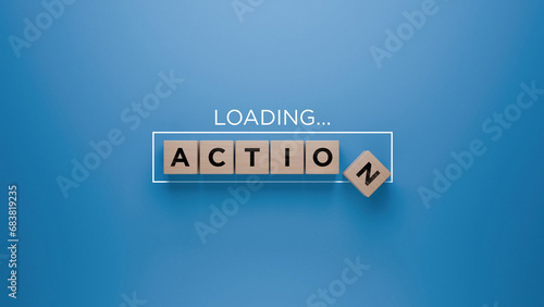 Wooden blocks spelling 'ACTION' with a loading progress bar on a blue background, initiative and execution concept
