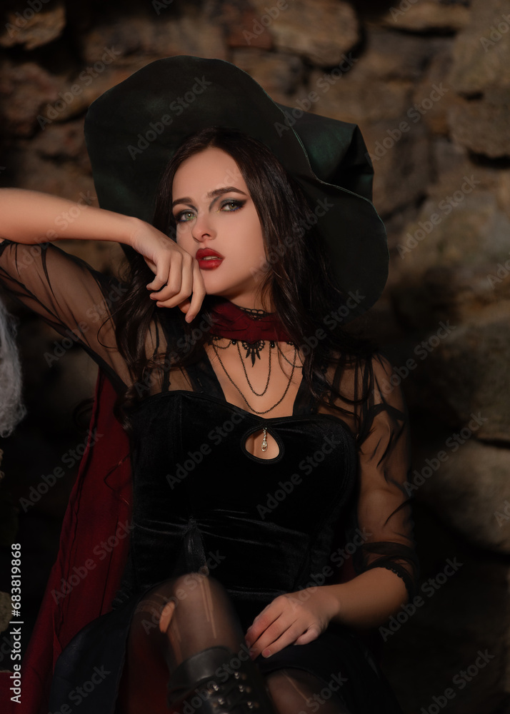 A portrait of a young sexy witch with outside. Magic, dark force, spell. Witchcraft. Halloween. A portrait of a young sexy witch with outside. Magic, dark force, spell. Witchcraft. Halloween.