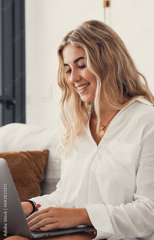 Portrait of one young attractive blonde woman using laptop pc computer on couch relaxing surfing the net at home. Working online concept lifestyle. Portrait of one young attractive blonde woman using laptop pc computer on couch relaxing surfing the net at home. Working online concept lifestyle.