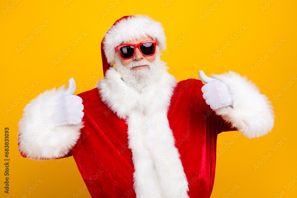 Photo of grandfather santa claus celebrate christmas thumbs up recommend big winter season sale advert isolated on yellow color background
