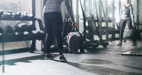 Athlete, walking and woman with a bag in gym ready to start exercise, workout or training on floor with weights. Fitness, club and legs of person with health, wellness and equipment in gymnasium photo