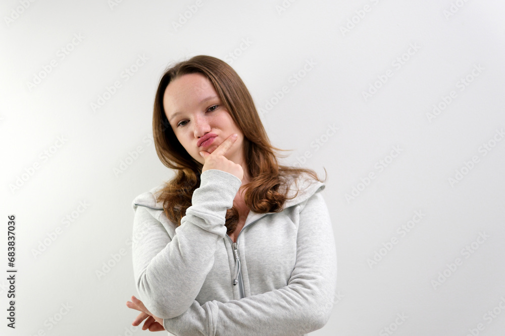 Confused girl shrugs and can not understand why she says so, confused and angry, wearing casual sportswear isolated on white background. Human reactions and perception Confused girl shrugs and can not understand why she says so, confused and angry, wearing casual sportswear isolated on white background. Human reactions and perception