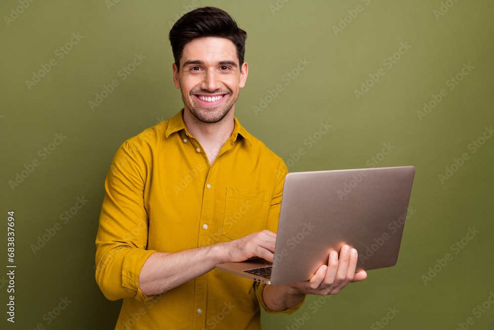 Photo of intelligent skilled corporate man use wireless laptop coworking isolated on khaki color background Photo of intelligent skilled corporate man use wireless laptop coworking isolated on khaki color background