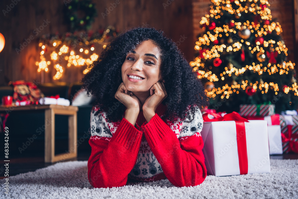 Photo of cute positive person laying carpet floor hands touch cheeks christmas time giftbox illumination decor house inside Photo of cute positive person laying carpet floor hands touch cheeks christmas time giftbox illumination decor house inside