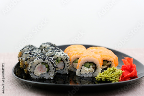 set Philadelphia and California oriental cuisine japanese food vegetarians adore on a beautiful dark background sushi bar outrageous rolls appetizing fish and rice wrapped in nura on atmospheric photo