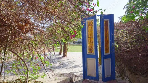 An antique door in an outdoor public garden helps calm and relax photo
