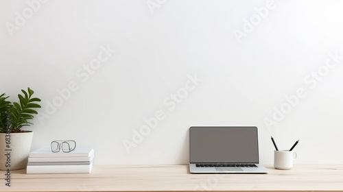 A clean, white minimalist workspace with a laptop, pens, and notebooks on the desk, and simple, uncluttered walls in the background.