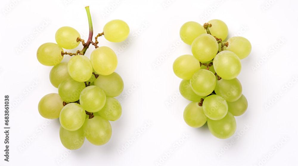 Cut bright-colored Muscat grapes on a pale background from above.