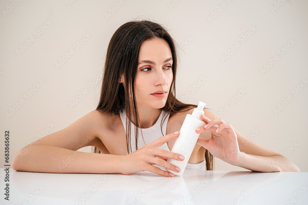 Young woman model holding hair care, skincare or bodycare cosmetics products Young woman model holding hair care, skincare or bodycare cosmetics products
