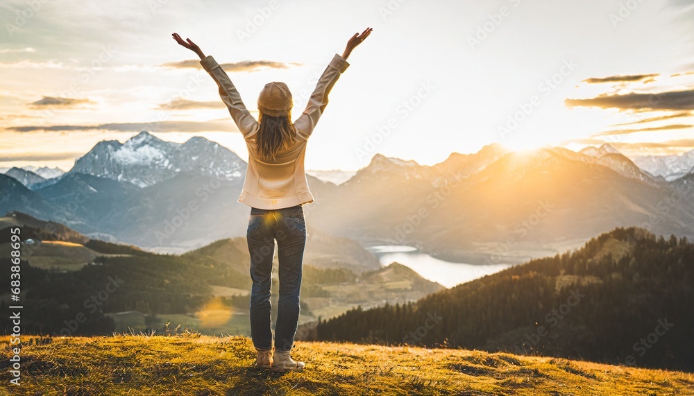 Φωτογραφία Success story: A woman on top of the mountain with arms open to a welcoming new day with sunrise success