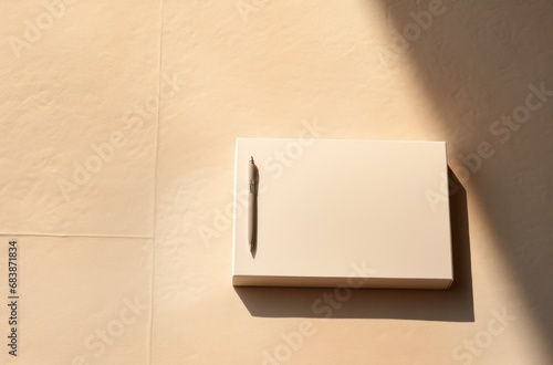 an empty paper box, pen, pens, and a notebook