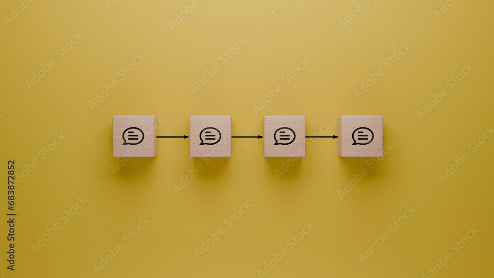 Communication flow and feedback loop concept illustrated with wooden blocks on yellow background, message exchange sequence, dialogue continuity visual, word of mouth concept Communication flow and feedback loop concept illustrated with wooden blocks on yellow background, message exchange sequence, dialogue continuity visual, word of mouth concept