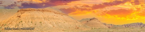 The red Boguty Mountains create a breathtaking panorama These mountains have been shaped by powerful forces of nature over the centuries Experience the serenity and tranquility of the desert landscape
