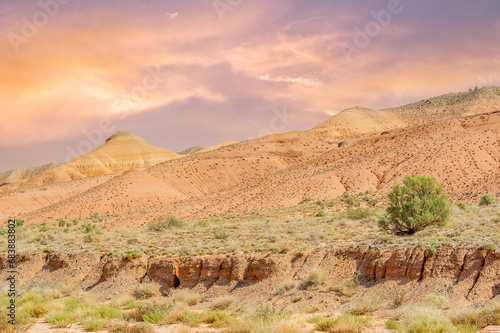 As you watch the sun gently descend over the vast expanse of tranquil mountains  you can t help but be mesmerized by the breathtaking symphony of colors that ignites a sense of wonder within.