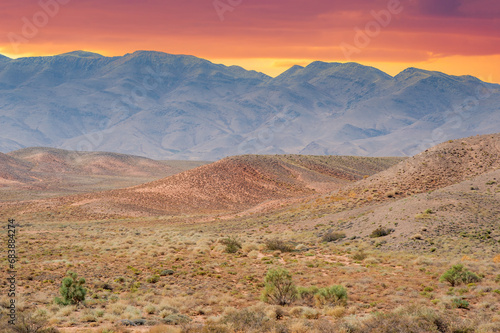 Witness an amazing display of vibrant colors at sunrise in the Red Boguta Mountains. Experience nature's breathtaking symphony as the sun sets over the tabletop mountain landscape.
