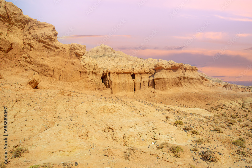 Red Mountains of Boguty. As the sun dips below the horizon, the mountains welcome you to a world of tranquility where sand and sky collide in a magical dance of colors. Desert Dreams