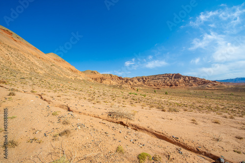 Enjoy the beauty of a desert sunset in the Red Boguta Mountains. Be mesmerized by the golden glow of the sun illuminating the jagged peaks. Witness a breathtaking and awe-inspiring spectacle