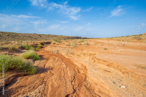 Enjoy the spectacular beauty of a mountain sunset. Witness nature s masterpiece as the sun sets over mountains of fiery red clay. Be captivated by the breathtaking colors and serene atmosphere.