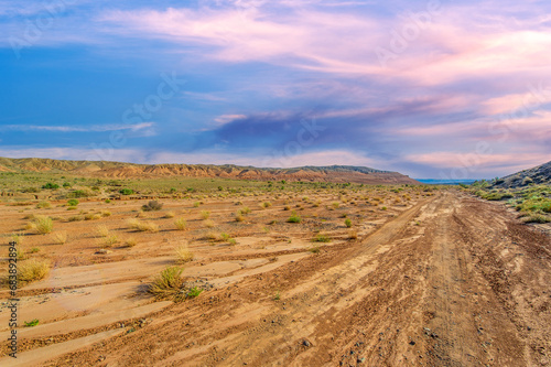 Enjoy the spectacular beauty of a mountain sunset. Witness nature s masterpiece as the sun sets over mountains of fiery red clay. Be captivated by the breathtaking colors and serene atmosphere.